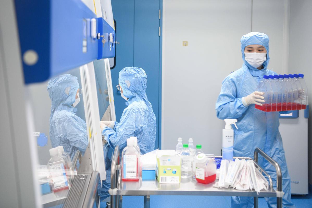 Technicians run drug experiments at a pharmaceutical company